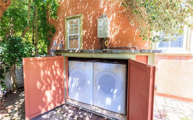 exterior space with washing machine and clothes dryer and stucco siding