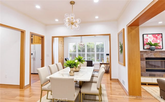 dining space with recessed lighting, light wood finished floors, and a chandelier