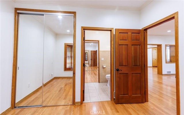 interior space with recessed lighting, tile walls, ornamental molding, and light wood-style flooring
