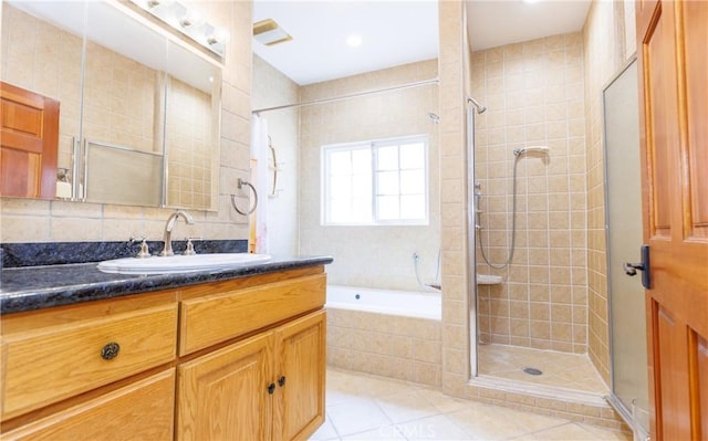 bathroom with a garden tub, visible vents, tile patterned flooring, a shower stall, and vanity