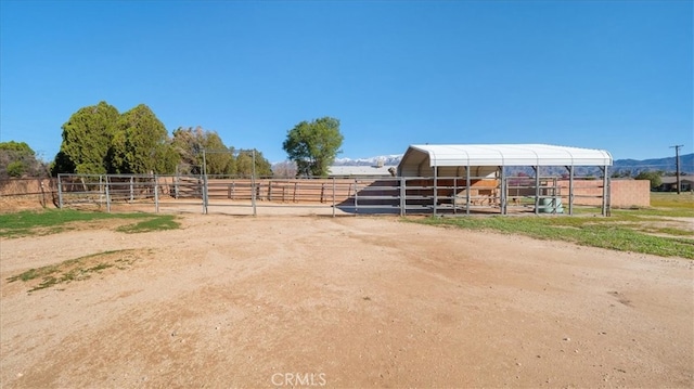view of horse barn featuring a rural view