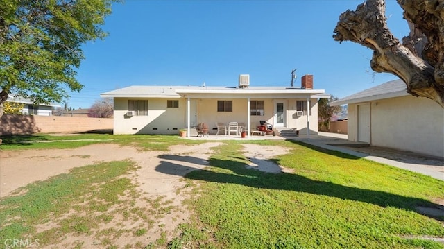 back of property with a chimney, a patio area, fence, a yard, and entry steps