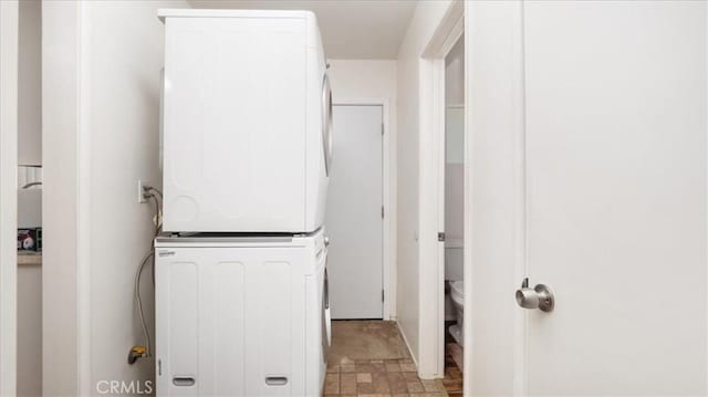washroom featuring laundry area and stacked washing maching and dryer