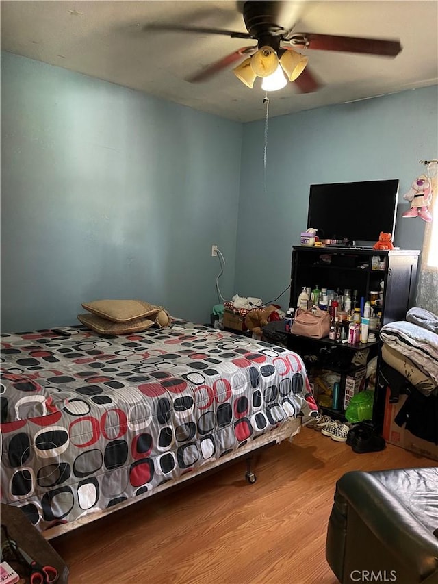 bedroom with ceiling fan and wood finished floors