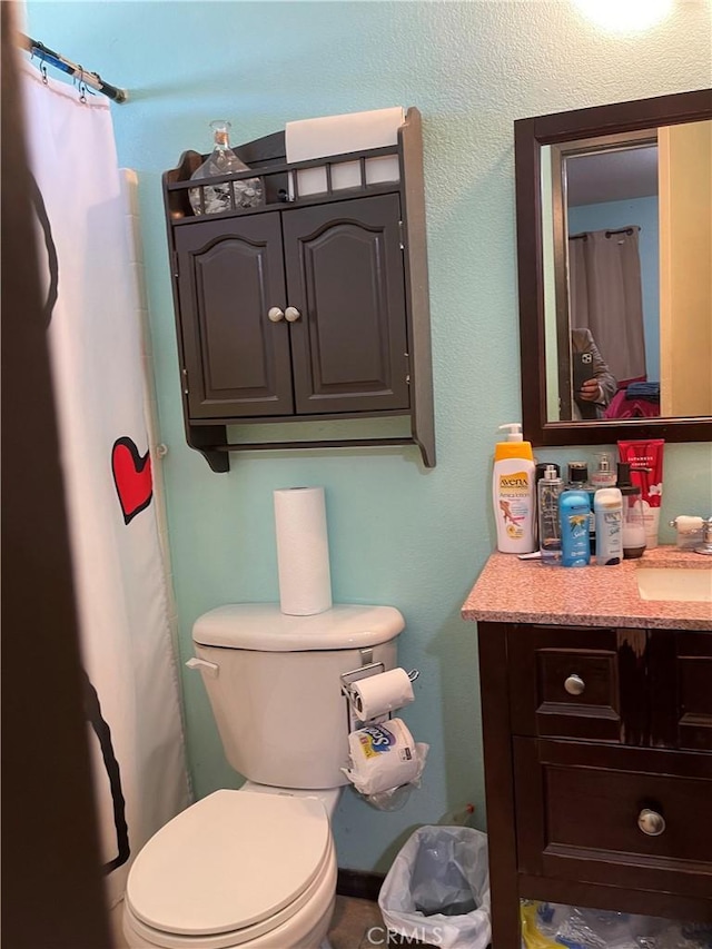 full bathroom with vanity and toilet