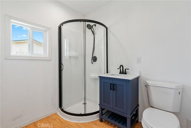 9235 Poplar St, Atascadero, CA 93422 - bathroom with a stall shower, wood finished floors, toilet, baseboards, and vanity