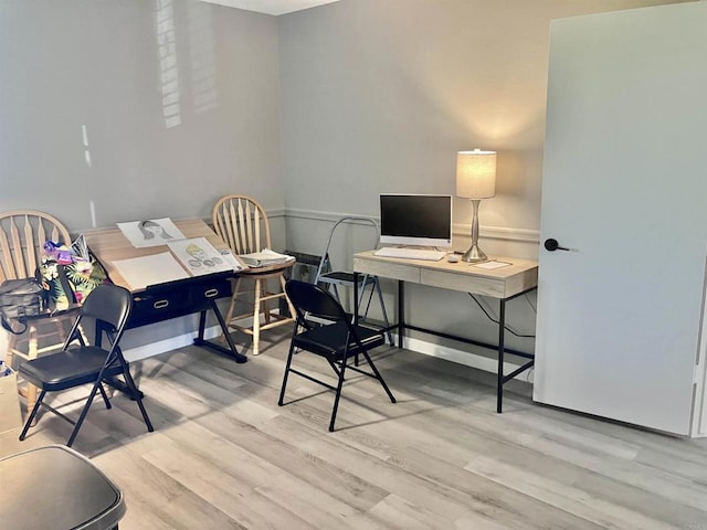 office featuring baseboards and light wood-style flooring