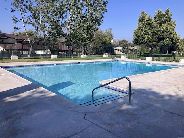 view of swimming pool with a fenced in pool, fence, and a patio