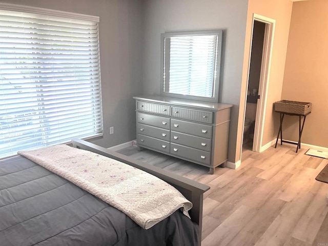 bedroom featuring baseboards and light wood-type flooring