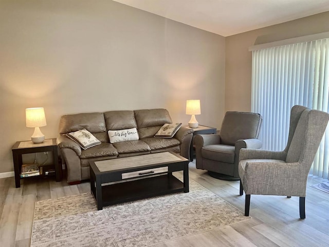 living room with baseboards and wood finished floors