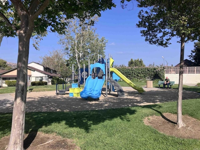 community jungle gym featuring a lawn