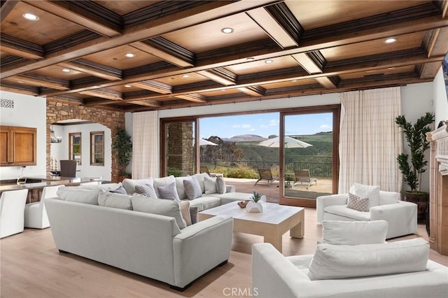 living area with recessed lighting, arched walkways, coffered ceiling, and beamed ceiling