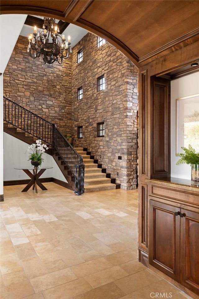 interior space with a notable chandelier and stairway