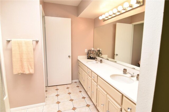 5727 E Stillwater Ave Unit 5, Orange, CA 92869 - bathroom featuring double vanity, baseboards, and a sink
