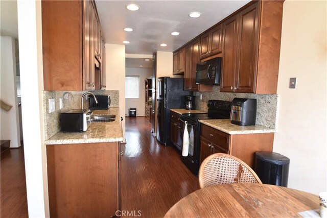 5727 E Stillwater Ave Unit 5, Orange, CA 92869 - kitchen featuring recessed lighting, tasteful backsplash, a sink, dark wood finished floors, and black appliances