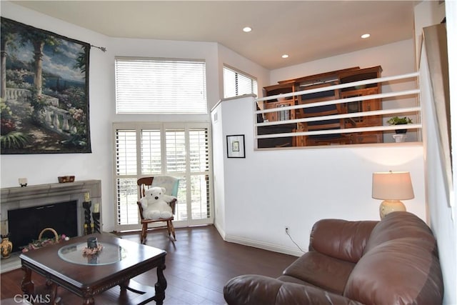 5727 E Stillwater Ave Unit 5, Orange, CA 92869 - living area featuring a fireplace with raised hearth, baseboards, recessed lighting, and wood finished floors