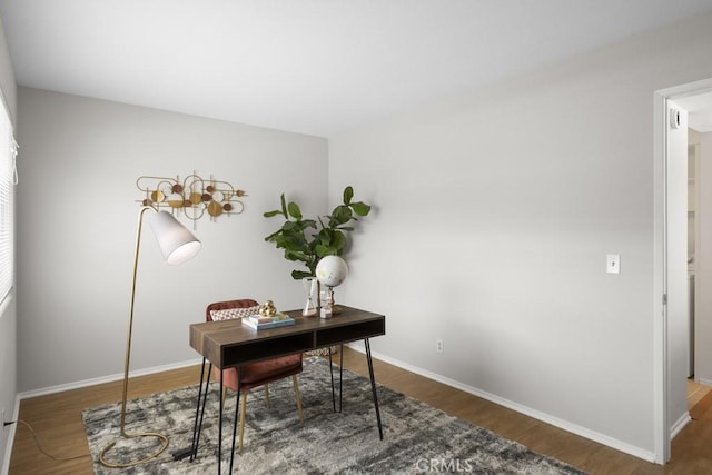 office area featuring baseboards and wood finished floors