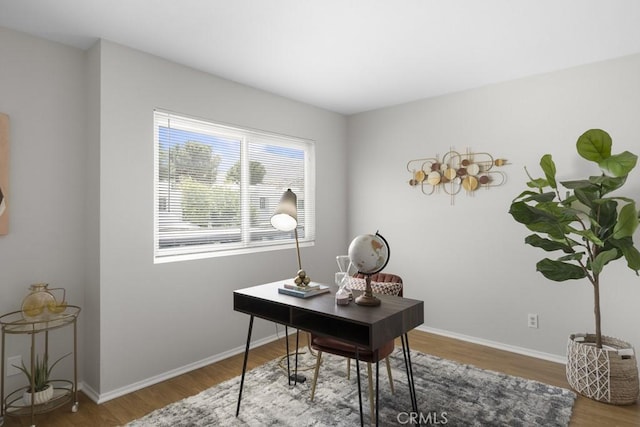 office space with baseboards and wood finished floors