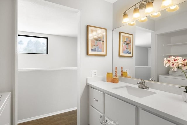bathroom with vanity, baseboards, toilet, and wood finished floors