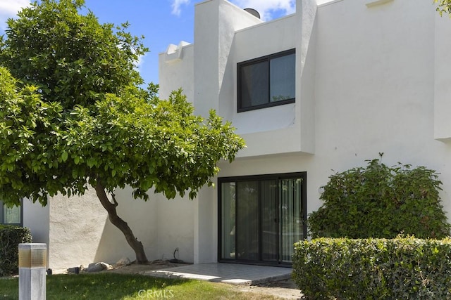 doorway to property with stucco siding