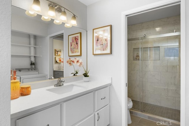 full bath featuring vanity, toilet, washer / dryer, and a stall shower