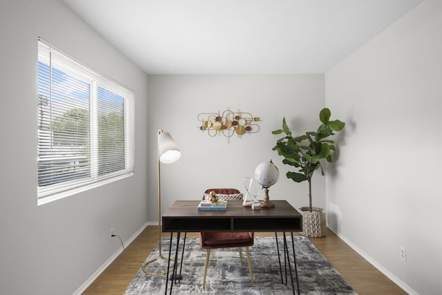 office area featuring baseboards and wood finished floors