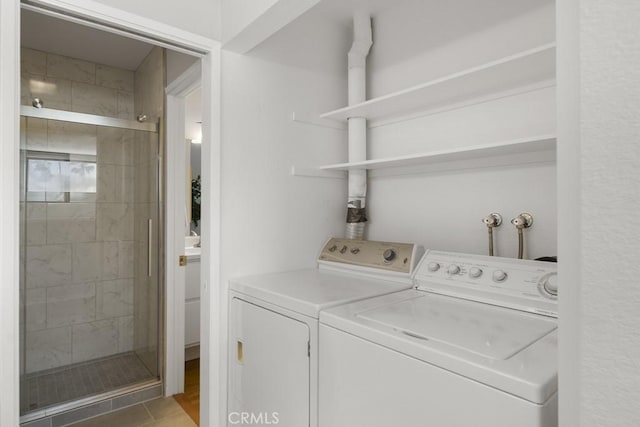clothes washing area with separate washer and dryer and laundry area