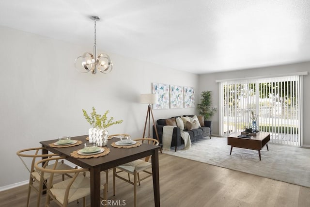 48668 Desert Flower Dr, Palm Desert, CA 92260 - dining space featuring wood finished floors, a chandelier, and baseboards