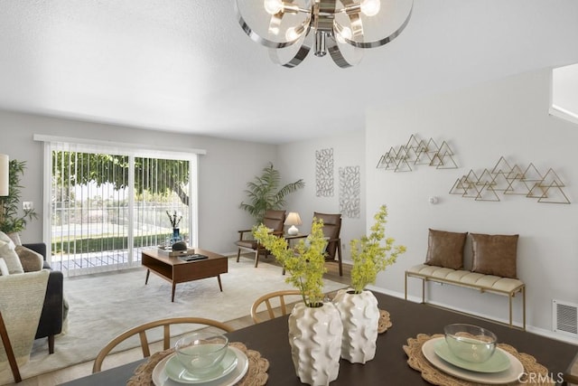 living area featuring a notable chandelier and visible vents