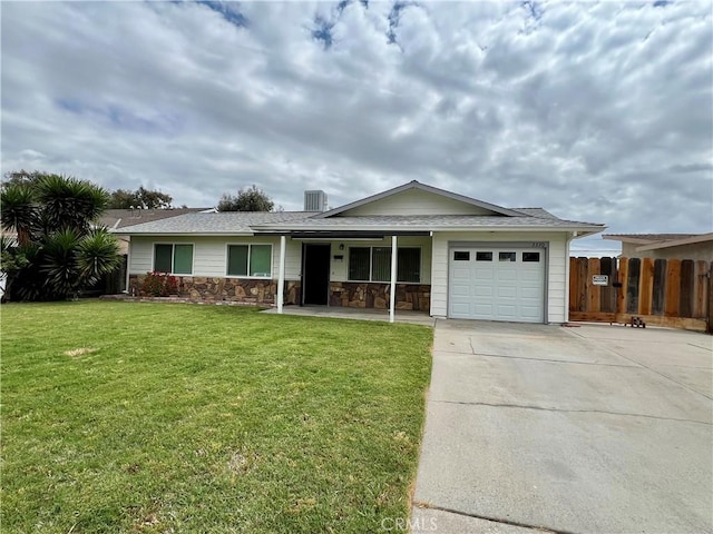 ranch-style home featuring a garage, fence, a front yard, concrete driveway, and a porch