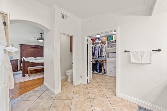 bathroom with a ceiling fan, visible vents, crown molding, toilet, and ensuite bathroom