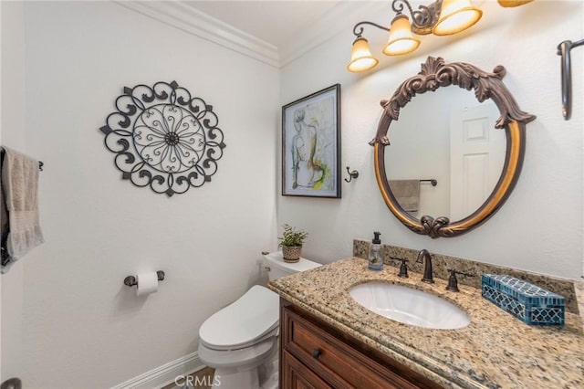 bathroom featuring vanity, ornamental molding, and toilet