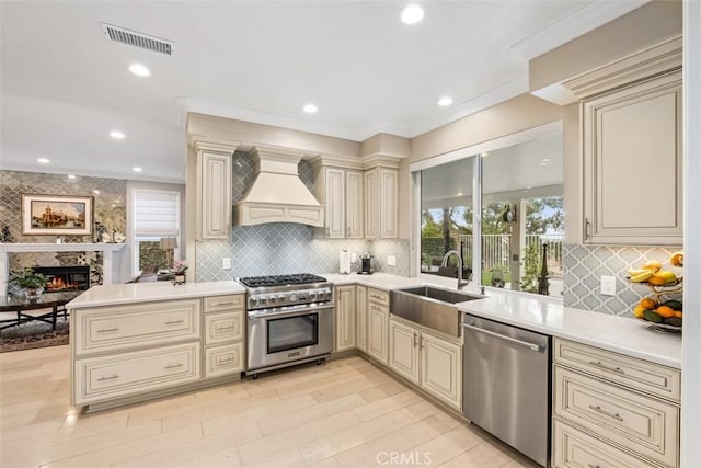 534 S Laureltree Dr, Anaheim Hills, CA 92808 - kitchen featuring cream cabinets, stainless steel appliances, a sink, custom range hood, and recessed lighting