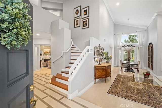 534 S Laureltree Dr, Anaheim Hills, CA 92808 - foyer featuring high vaulted ceiling, stairs, a chandelier, ornamental molding, and baseboards