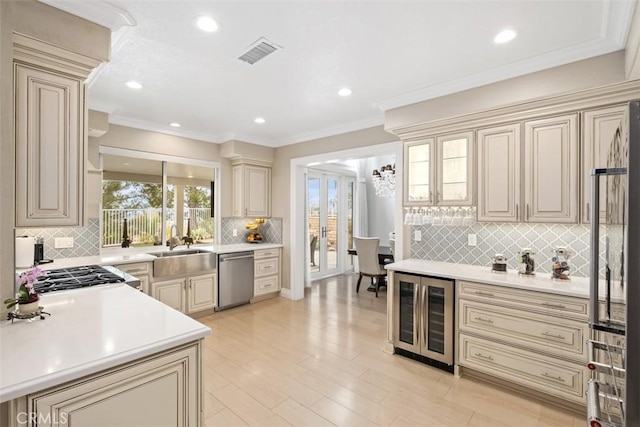 534 S Laureltree Dr, Anaheim Hills, CA 92808 - kitchen featuring cream cabinets, beverage cooler, appliances with stainless steel finishes, tasteful backsplash, and light countertops