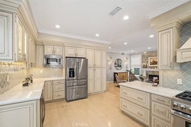 534 S Laureltree Dr, Anaheim Hills, CA 92808 - kitchen with cream cabinetry, stainless steel appliances, light countertops, light wood-style flooring, and recessed lighting