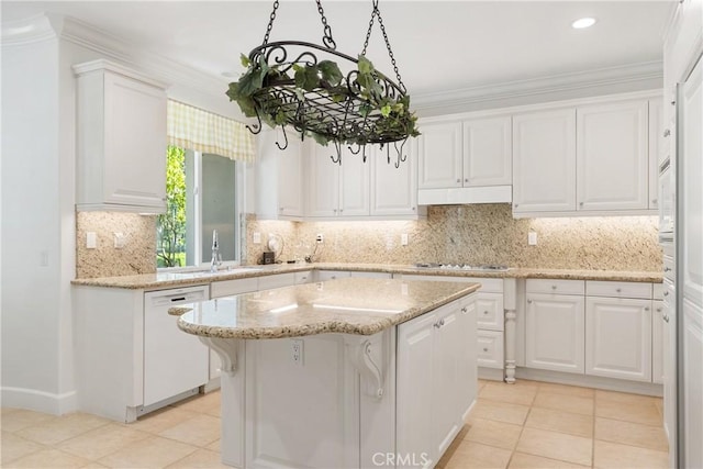 kitchen featuring a center island, ornamental molding, white cabinets, and white appliances