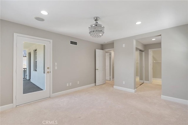 unfurnished bedroom with light colored carpet, recessed lighting, baseboards, and visible vents