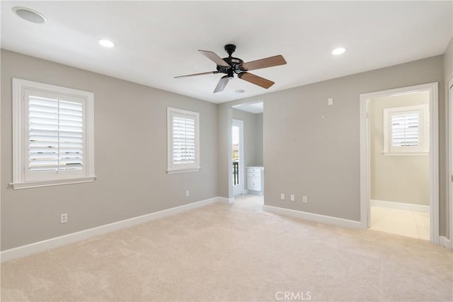 empty room featuring baseboards, recessed lighting, ceiling fan, and light carpet