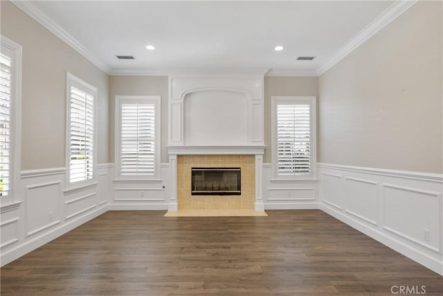 unfurnished living room with dark wood-style floors, a tile fireplace, and visible vents
