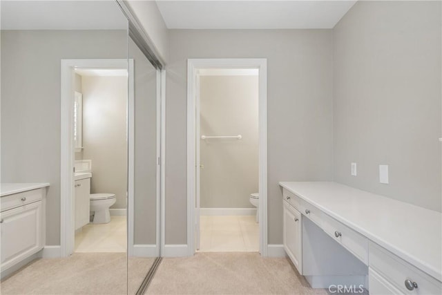 full bathroom with toilet, baseboards, and vanity