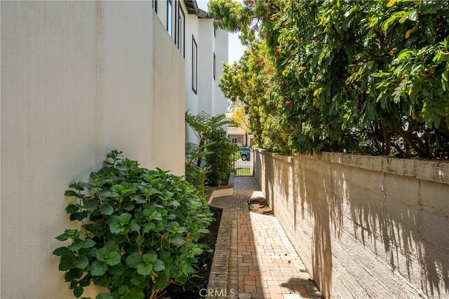view of home's exterior with fence and stucco siding
