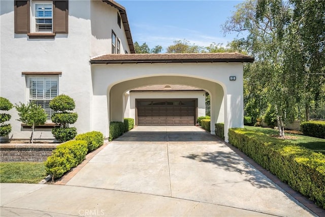 exterior space with a garage and concrete driveway