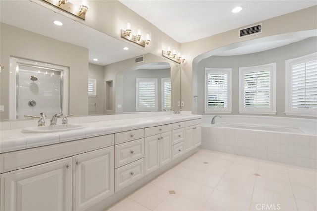 full bathroom with a sink, plenty of natural light, and visible vents