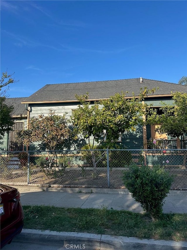 201 E Adele St, Anaheim, CA 92805 - view of front of property with a fenced front yard and roof with shingles