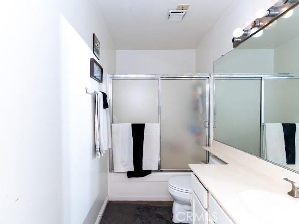 909 Shady Ln, Glendora, CA 91740 - bathroom with vanity, toilet, and bath / shower combo with glass door
