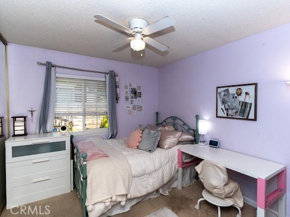909 Shady Ln, Glendora, CA 91740 - carpeted bedroom featuring a textured ceiling and a ceiling fan
