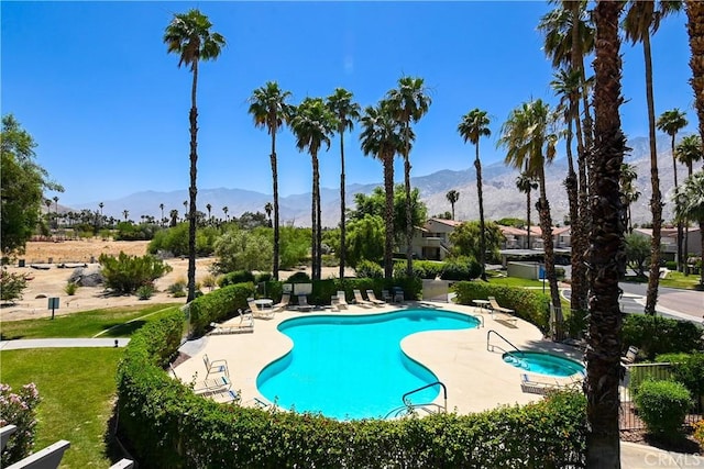 pool featuring a mountain view and a patio area