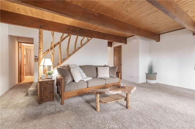 living area featuring carpet flooring, beamed ceiling, wood ceiling, and stairway