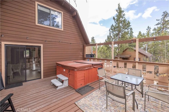 wooden deck with a hot tub